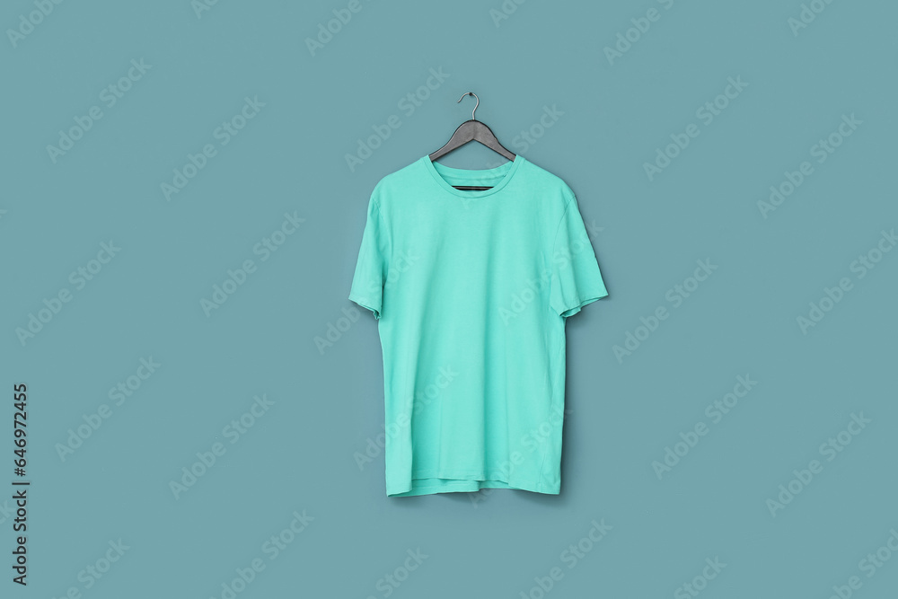 Stylish t-shirt hanging on blue background