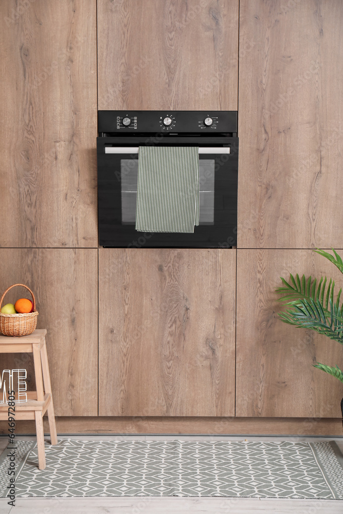 Stylish rug near oven in modern kitchen