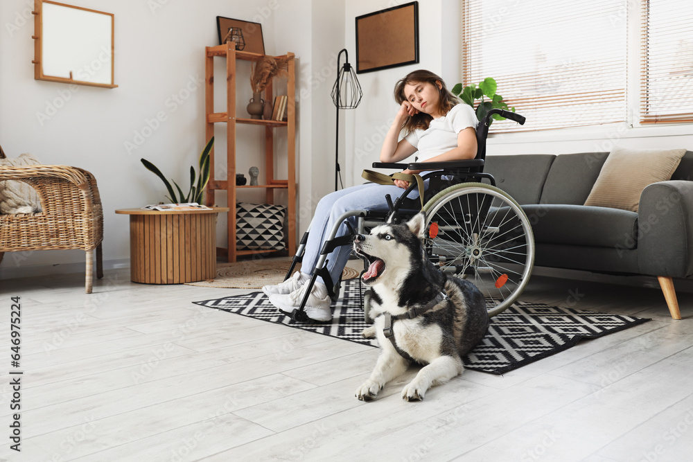 Sad woman in wheelchair and with husky dog at home