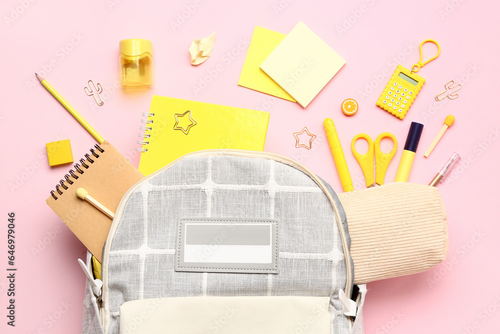 Stylish school backpack with different stationery supplies on pink background