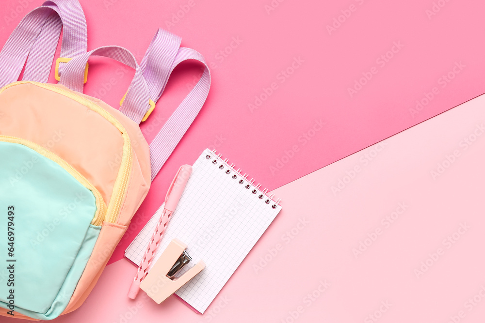 Stylish school backpack with different stationery supplies on pink background