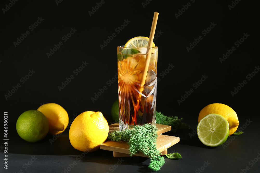 Glass of cold Long Island iced tea on dark background