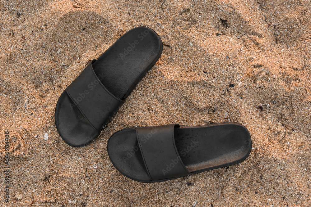 Stylish flips flops on sand at resort