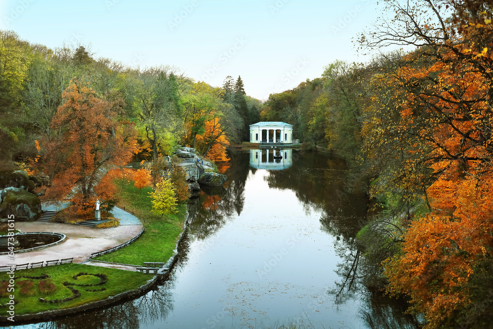 View of beautiful autumn park with trees and lake