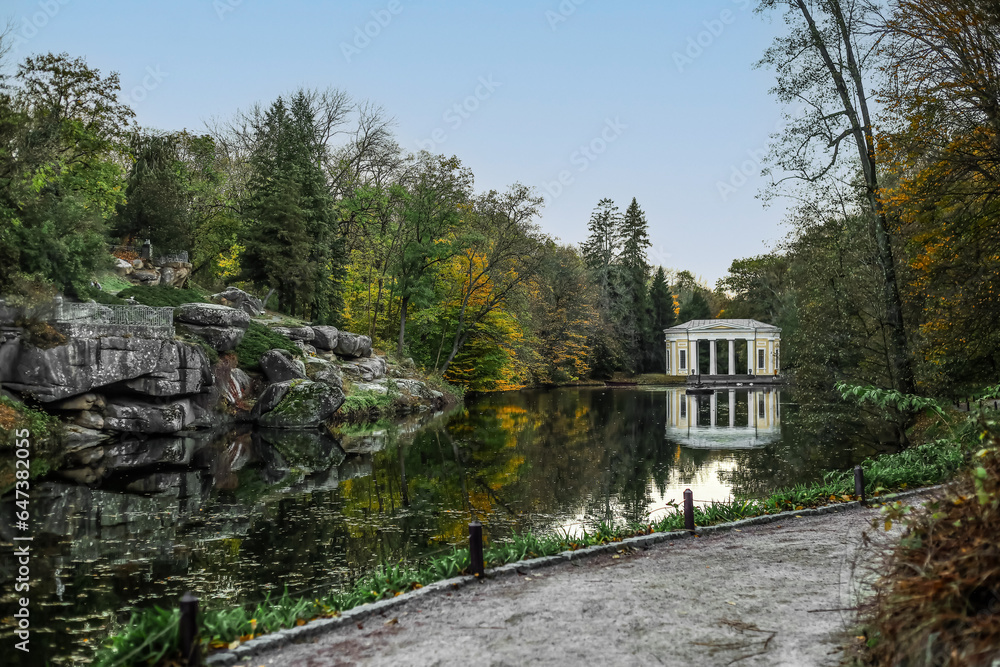 View of beautiful autumn park with lake and trees