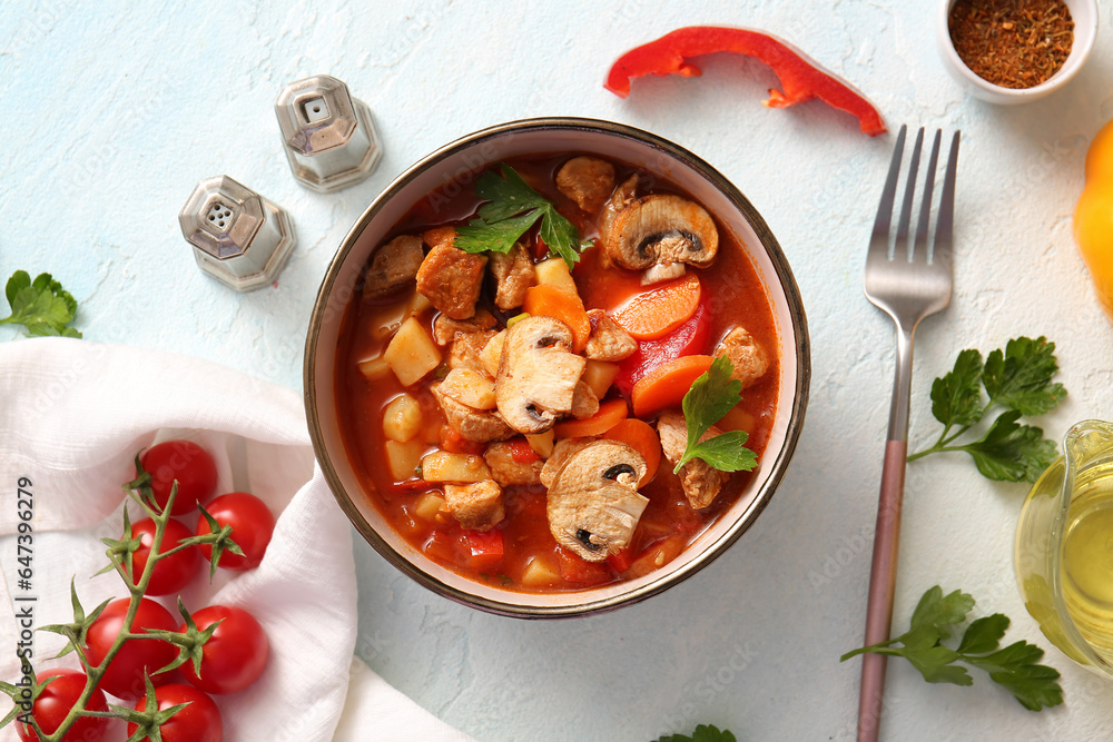 Bowl of tasty beef stew on white background