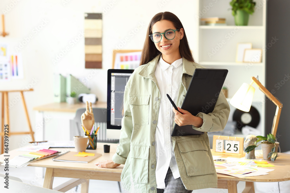 Female interior designer with graphic tablet in office