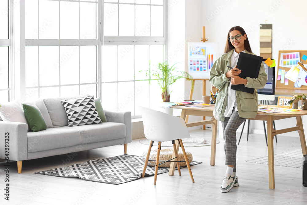 Female interior designer with graphic tablet in office