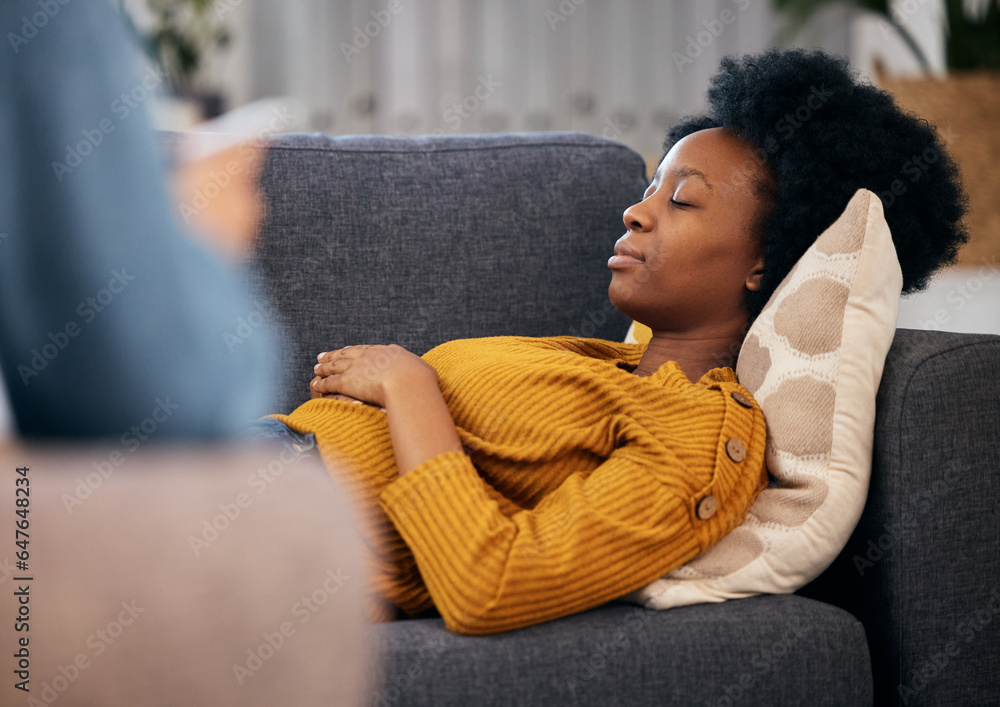 Therapy, sofa and black woman relax in consultation for mental health, help and listening to communi