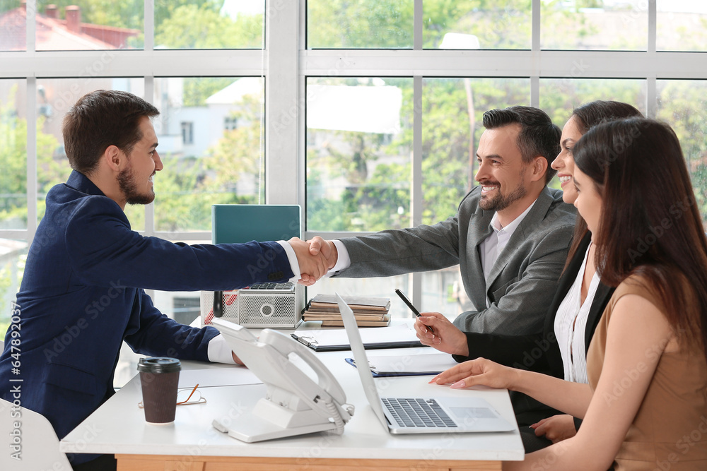 Human resources manager shaking hands with male applicant in office