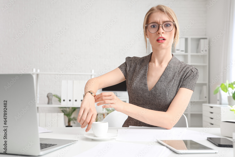 Young businesswoman working under deadline in office