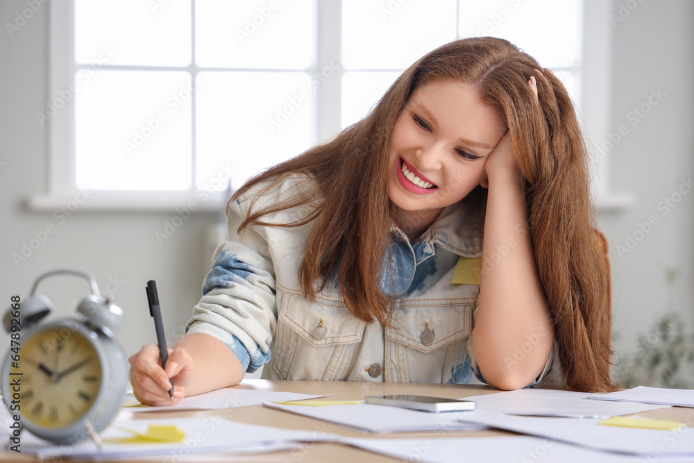 Stressed young businesswoman working under deadline in office