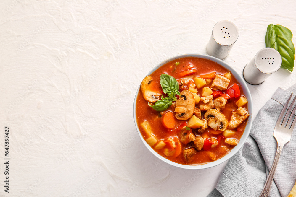 Bowl of tasty beef stew on white background