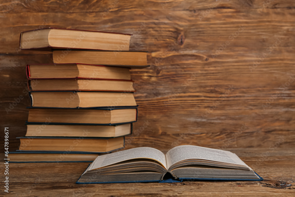 Open old hardcover book on wooden background