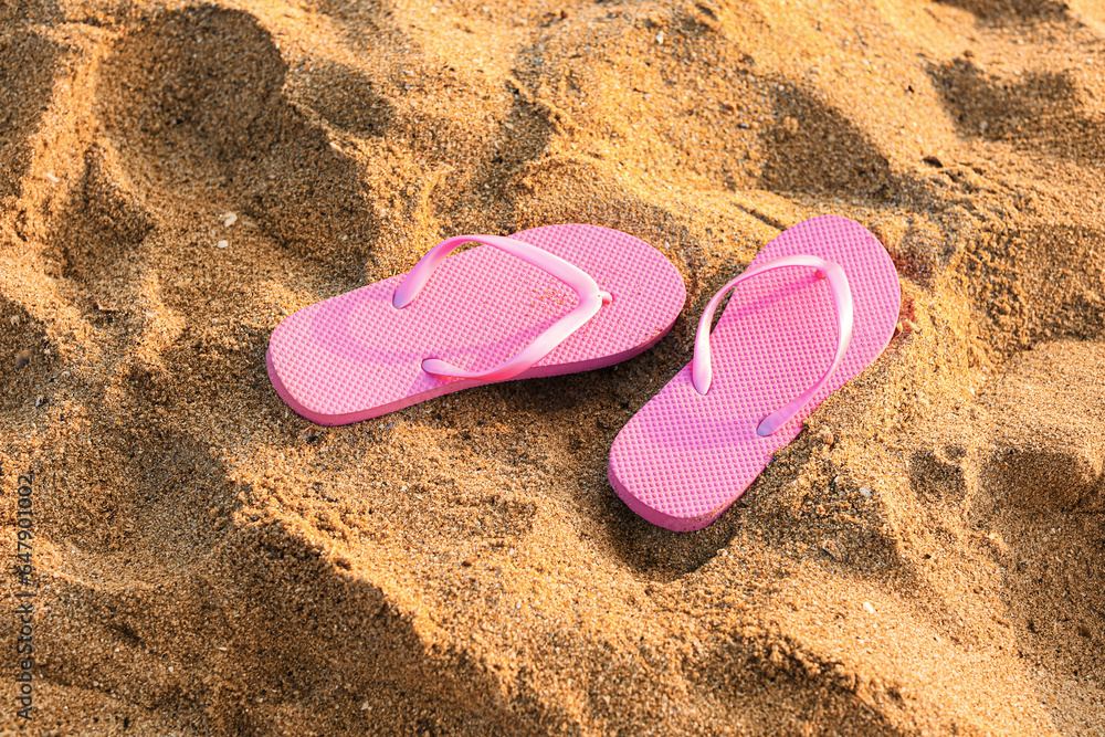 Stylish flips flops on sand at resort