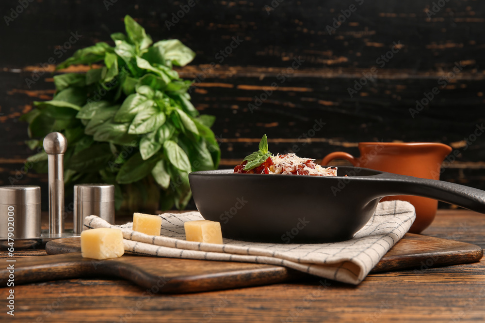 Frying pan with tasty pasta carbonara on table