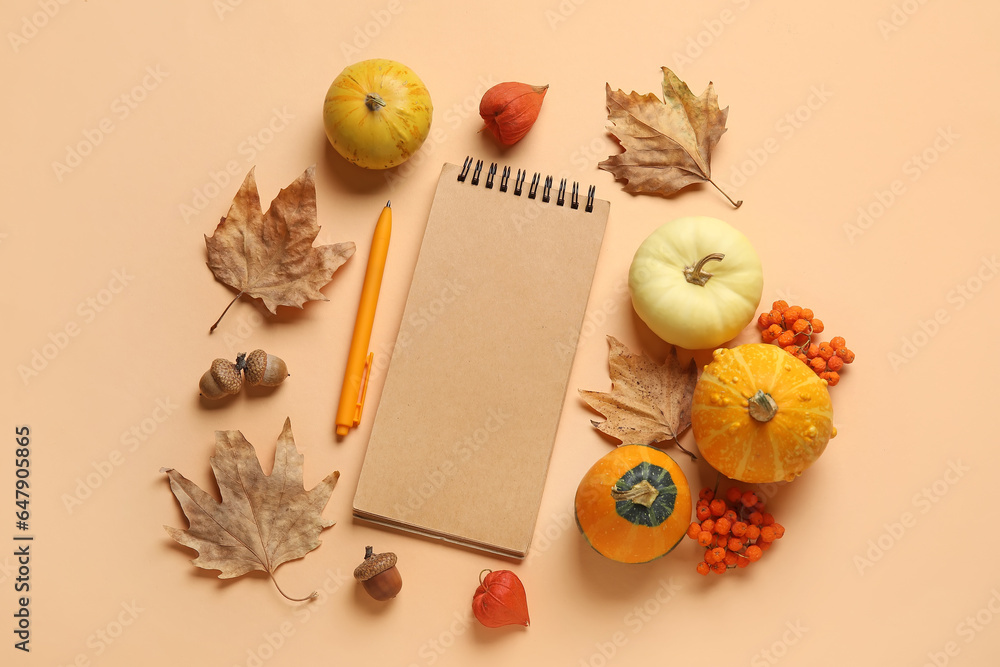 Composition with blank notebook, pen, pumpkins and natural forest decor on color background