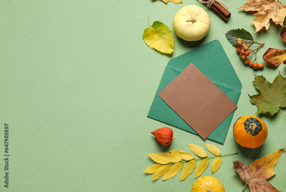 Composition with blank card, pumpkins and natural forest decor on color background