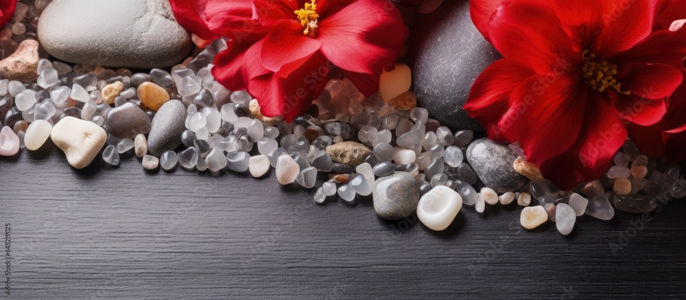 White gemstones spelling Home on a stone backdrop with red flowers