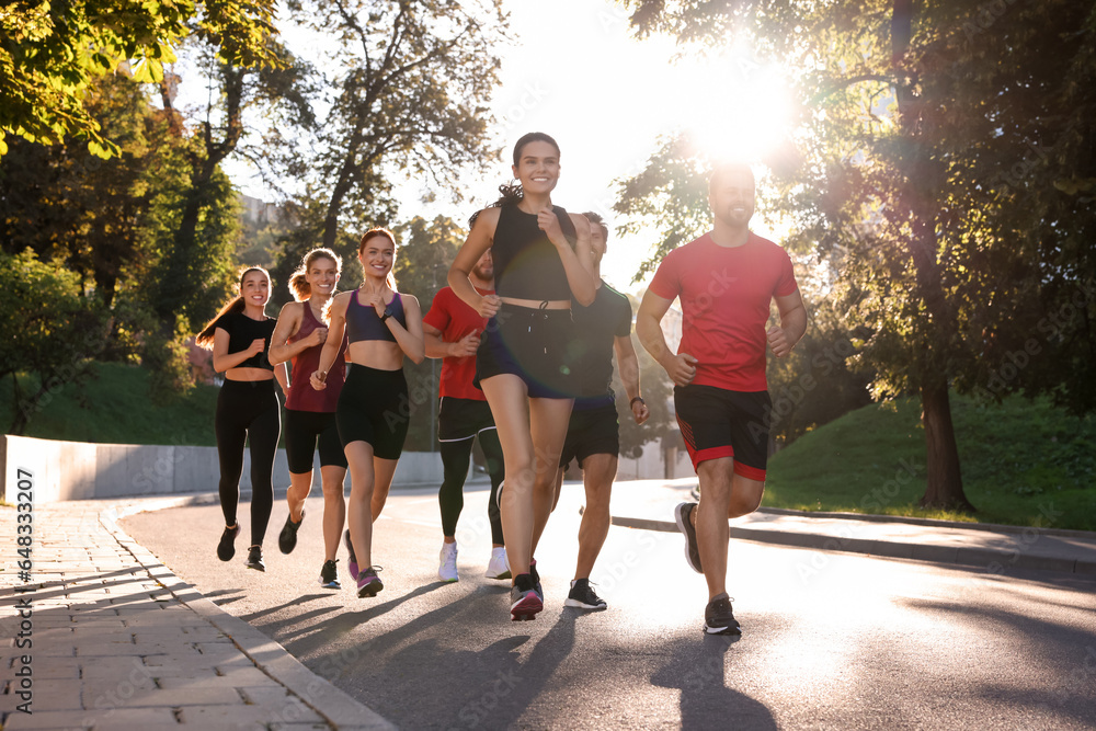 Group of people running outdoors on sunny day