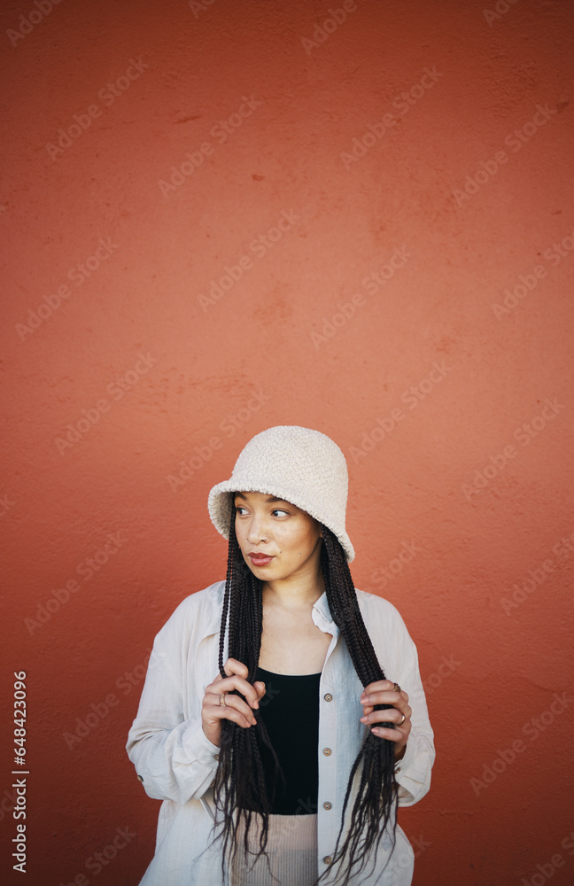 Fashion, style and woman in city on orange wall background with trendy outfit, cool clothes and stylish. Beauty, glamour and person with confidence, pride and cosmetics in town on mockup space