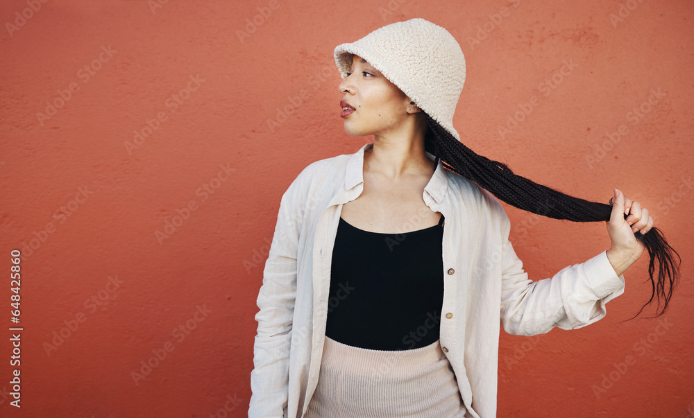 Fashion, hair and black woman in city with trendy outfit, cool clothes and style for glamour. Beauty, makeup and African person on orange wall background with confidence, pride and cosmetics in town