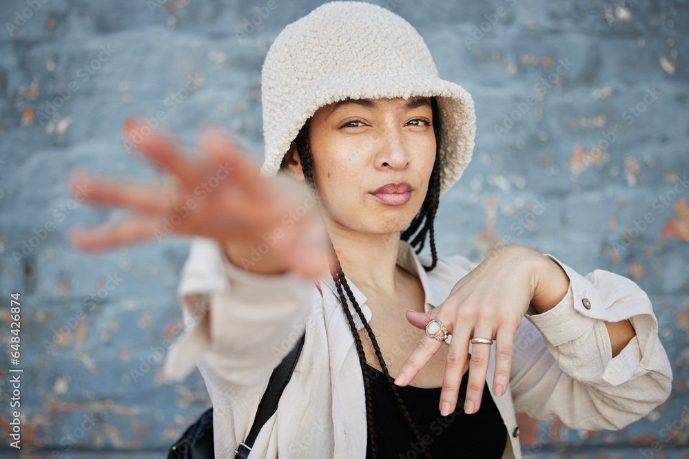 Fashion, hands and portrait of woman in city with trendy outfit, cool clothes and style for glamour. Beauty, creative and person on gray wall background with confidence, pride and cosmetics in town