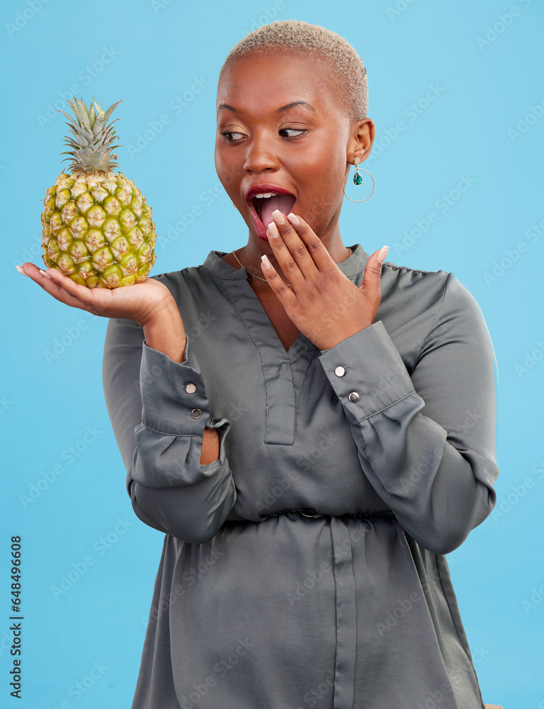 Pineapple, wow and surprise with a health black woman in studio on blue background for diet or nutrition. Wellness, fruit or food with a young person looking shocked by vitamins or minerals benefits