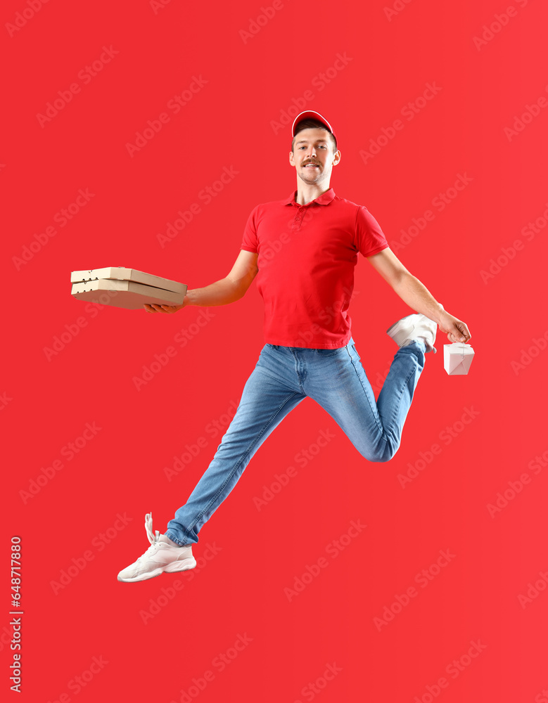 Jumping courier with food on red background