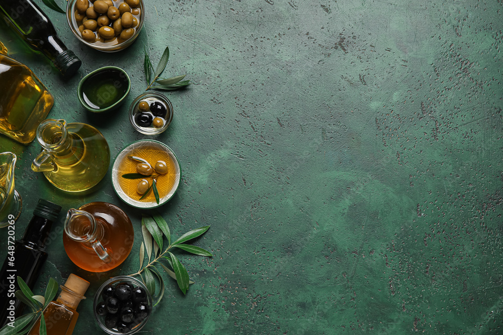 Bowls and glassware of fresh olive oil on green background