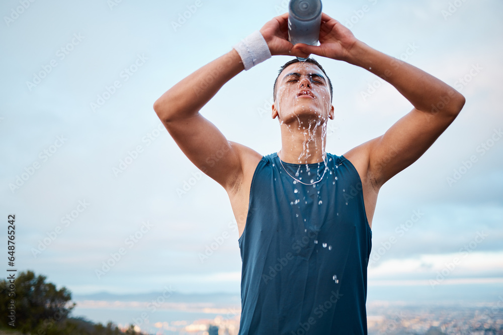 Exercise, water and fatigue with a sports man outdoor, tired after running a marathon for cardio training. Fitness, health and an exhausted young runner pouring liquid for hydration or refreshment