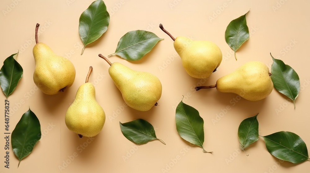 Pears and leaves on yellow background, Top view.