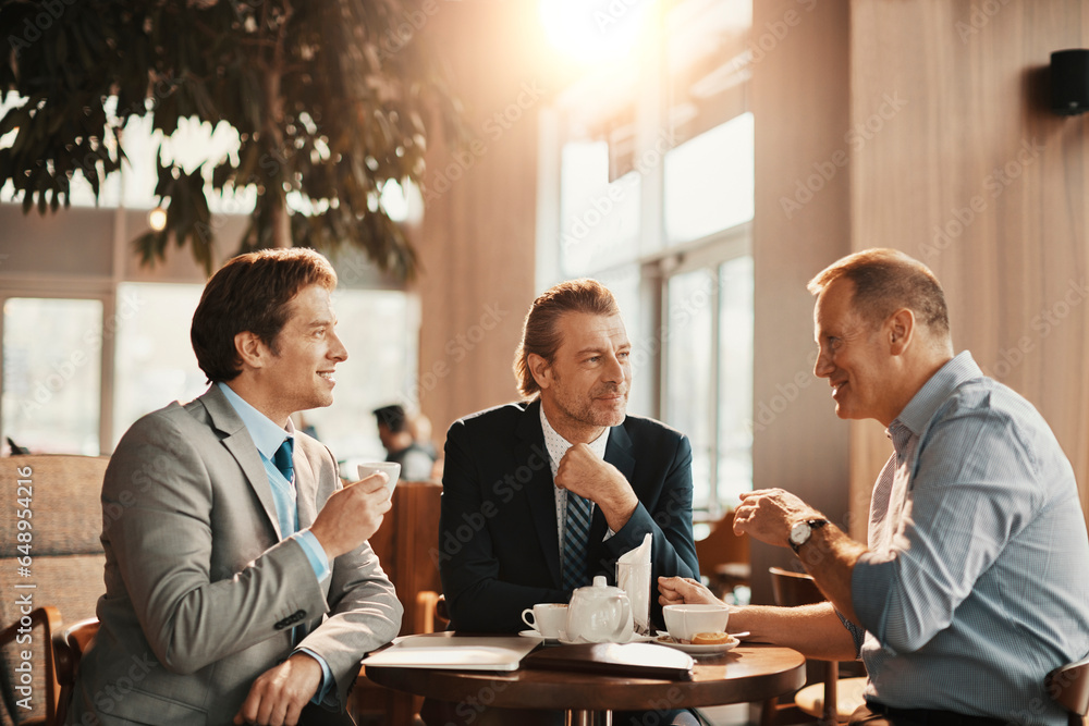 Middle aged business people having a meeting in a cafe decorated for christmas and the new year holidays