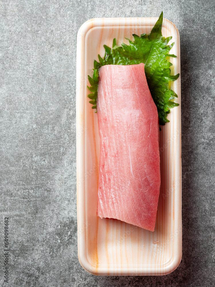 Raw tuna chunks in a disposable container