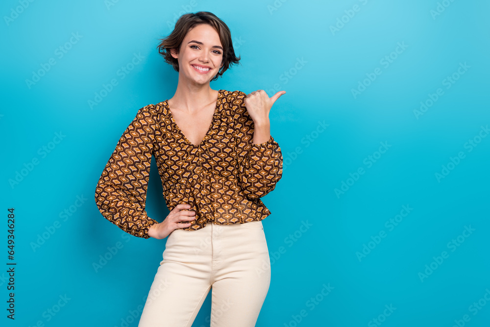 Photo of funny marketing promoter seo manager woman recommend her digital course point finger mockup isolated on blue color background