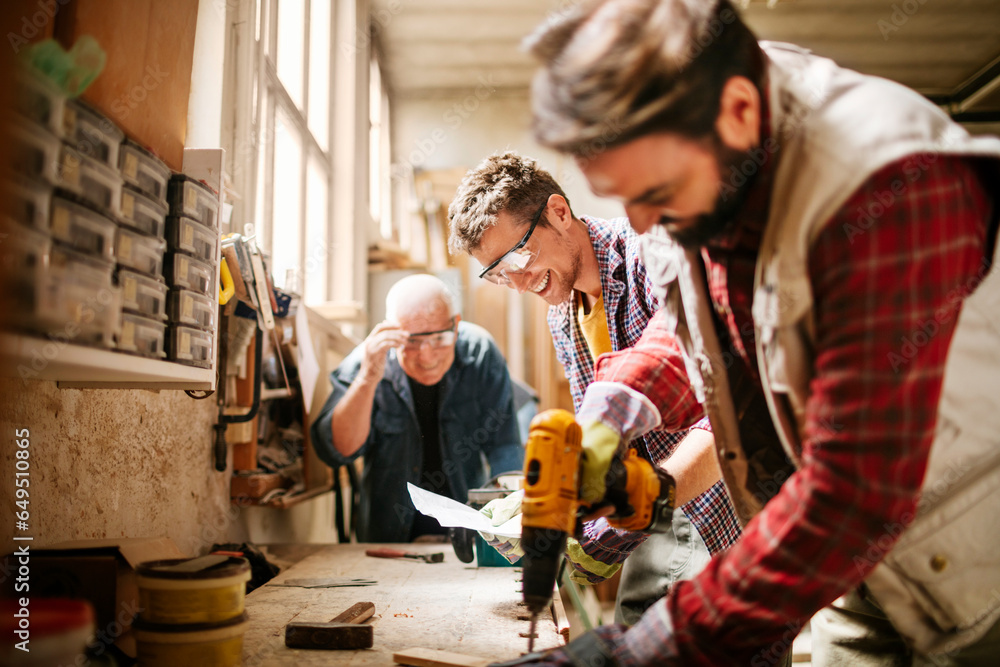 Diverse age group of carpenters working in a carpenter shop