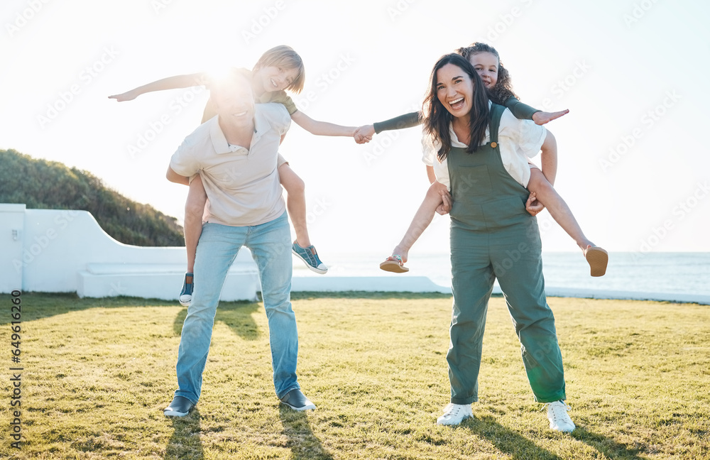 Family, parents and portrait of children on grass by ocean for bonding, relationship and relax together. Nature, travel and happy mother, father carrying kids on holiday, summer vacation and playing