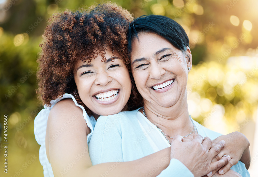 Happy, portrait and woman hugging her senior mother in nature at an outdoor park in summer. Smile, love and young female person from Mexico embracing her elderly mom with care in a field for bonding.