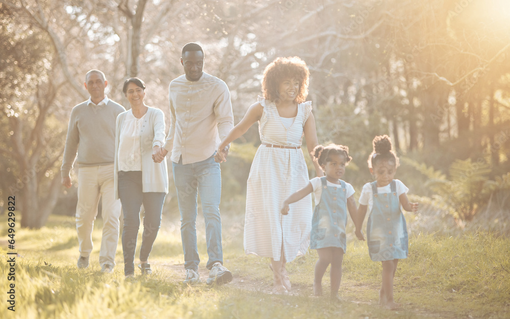 Big family in park, holding hands and walking together for love, bonding on nature adventure. Mother, father and children in garden with grandparents, parents and kids on path in woods or forrest.