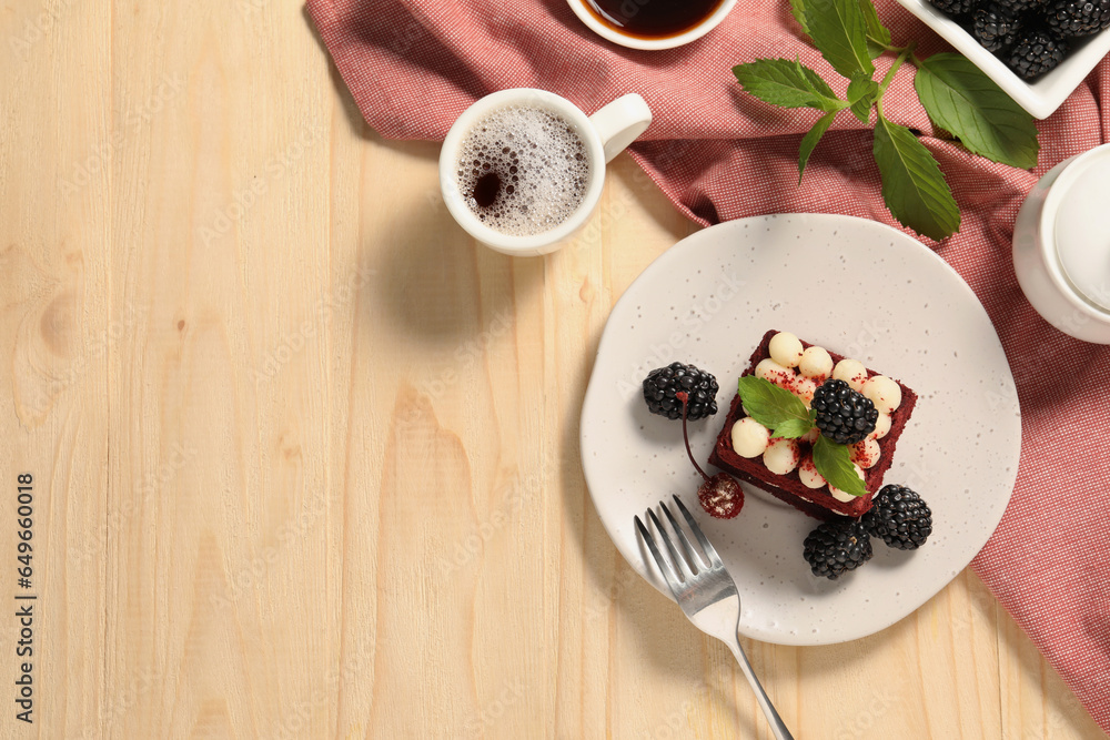 Piece of delicious red velvet cake with fresh berries served on wooden table, flat lay. Space for text