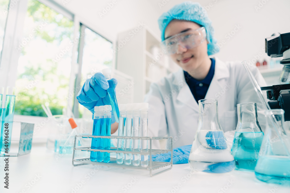 Scientist analyzing and dropping a sample into a glassware, Medicine science experiments containing chemical liquid in laboratory on glassware, innovative and technology.