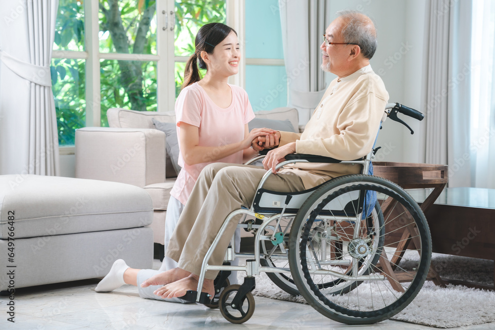 Asian family health care and insurance business at home concept, woman daughter take care support to senior elderly father patient in wheelchair together, dad having smile in happy love lifestyle