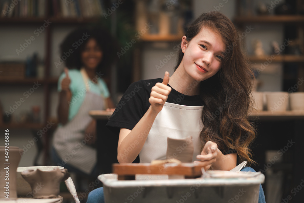 happy smiling girl having fun to learning and work with craft art of clay hand-made workshop in ceramic studio, little ceramist enjoy in creative handcraft hobby with pottery artisan school class