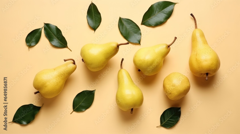 Pears and leaves on yellow background, Top view.