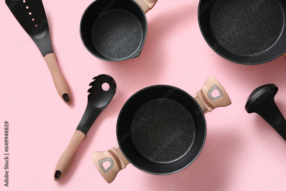 Set of kitchen utensils on pink background