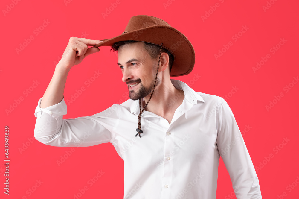 Handsome cowboy on red background