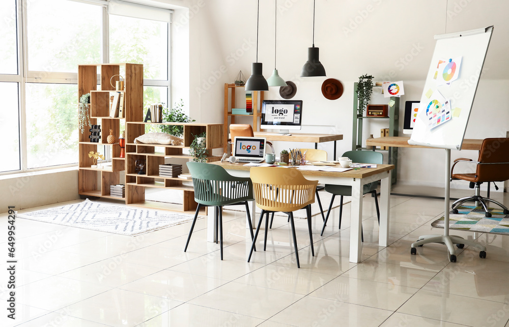 Interior of office with graphic designers workplaces