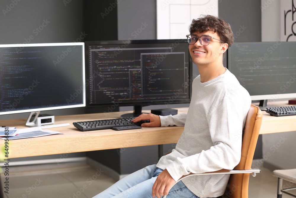 Male programmer working at table in office