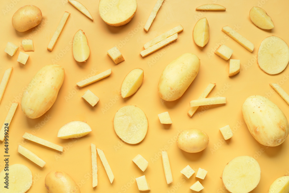 Whole and cut potatoes on yellow background