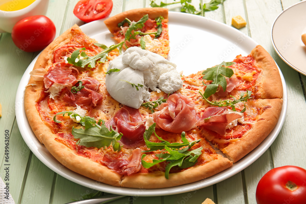 Plate of tasty pizza with Burrata cheese on green wooden